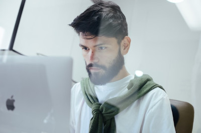 A man focused on his computer display
