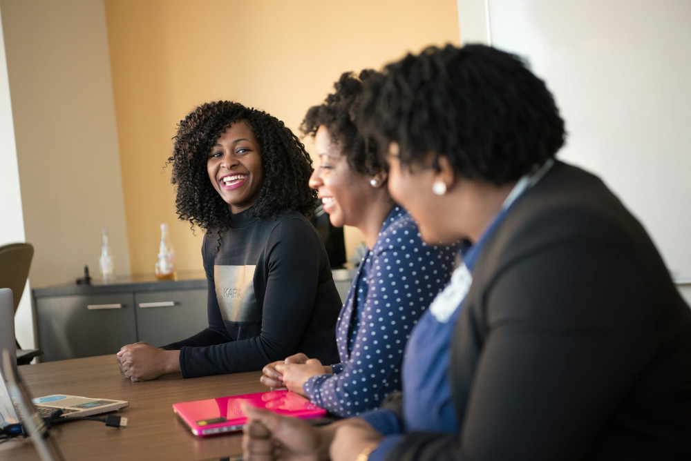 A group of colleagues talking at an office desk