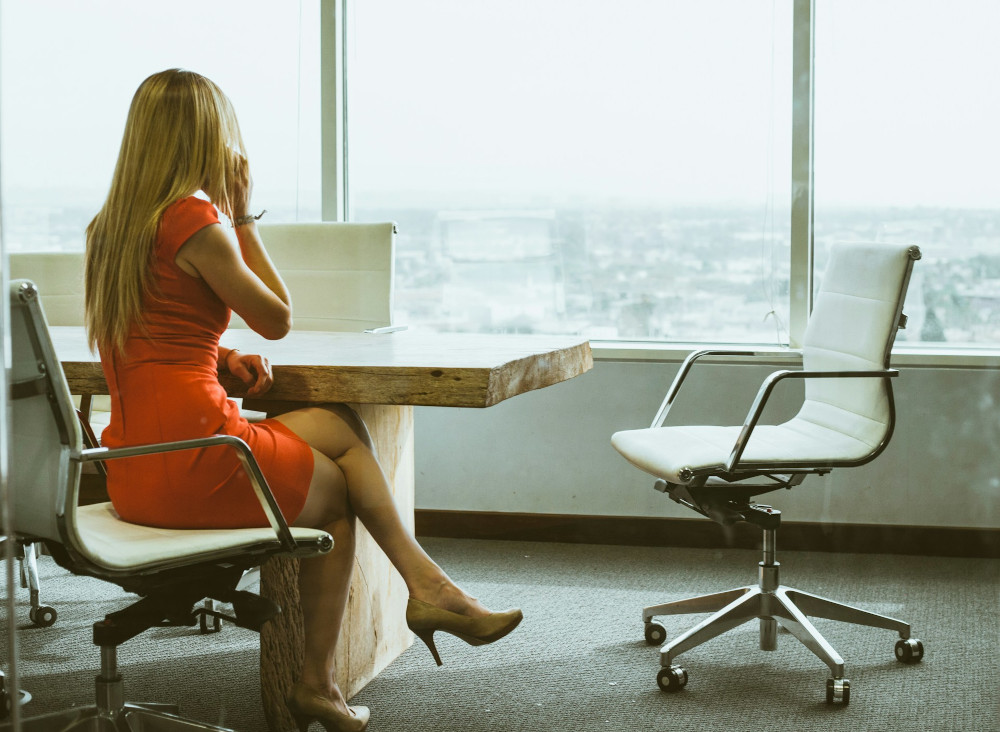 Woman making a call in an empty conference room