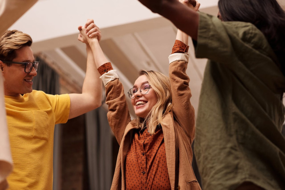 Design the workflow not your team calendar A team celebrating their joined success