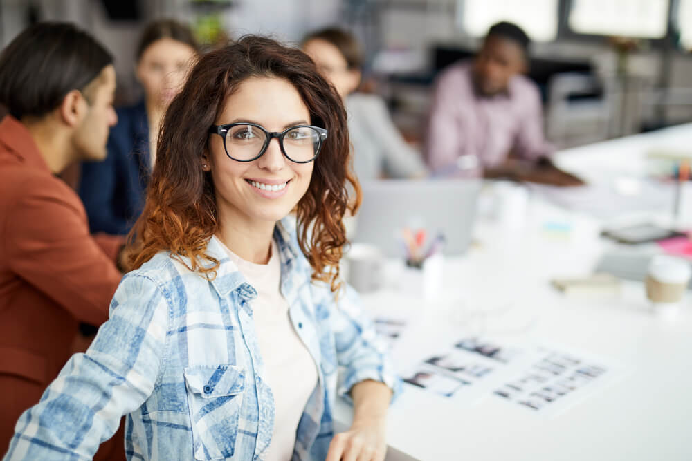 Woman sitting with a team at an office table