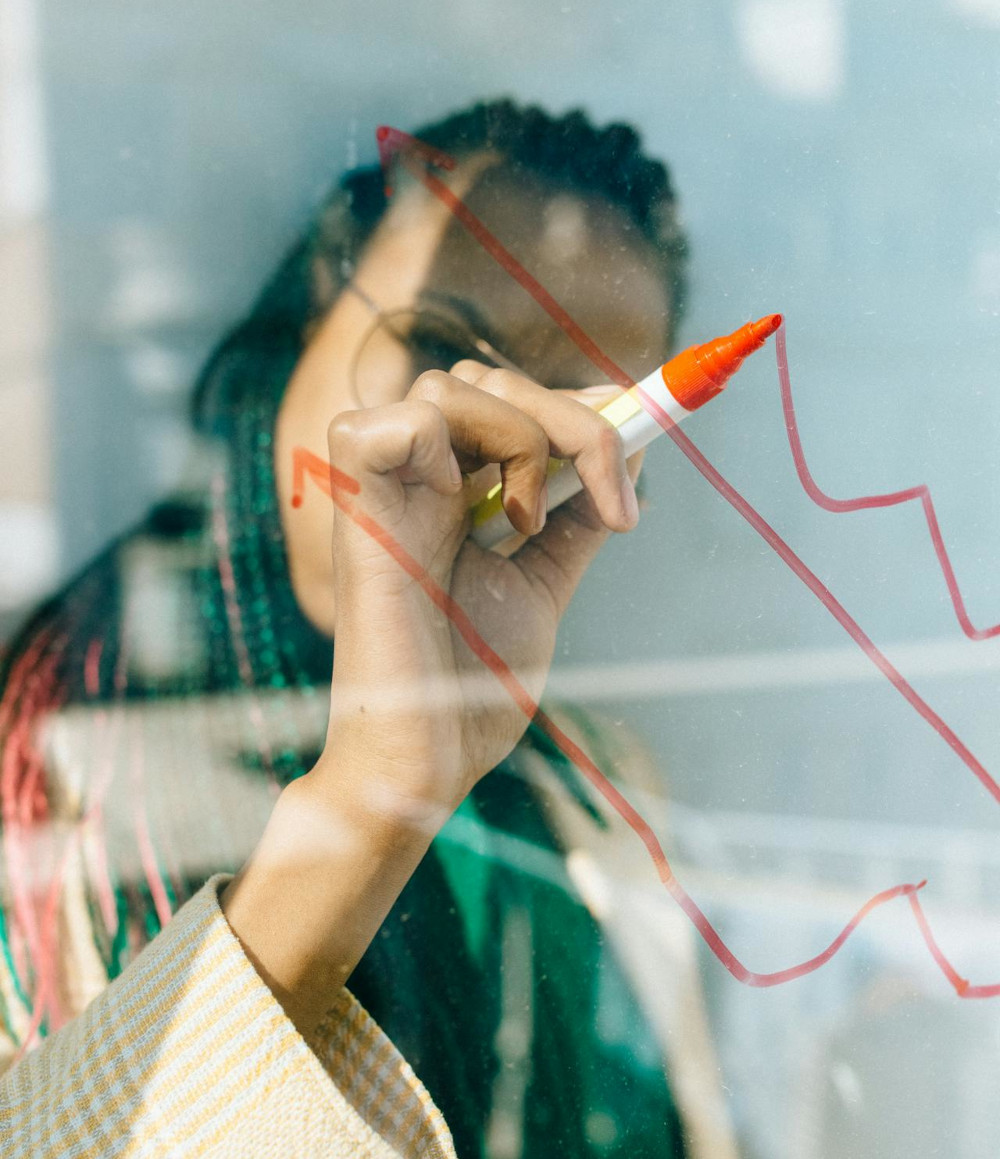 A business woman points to process metric graphs