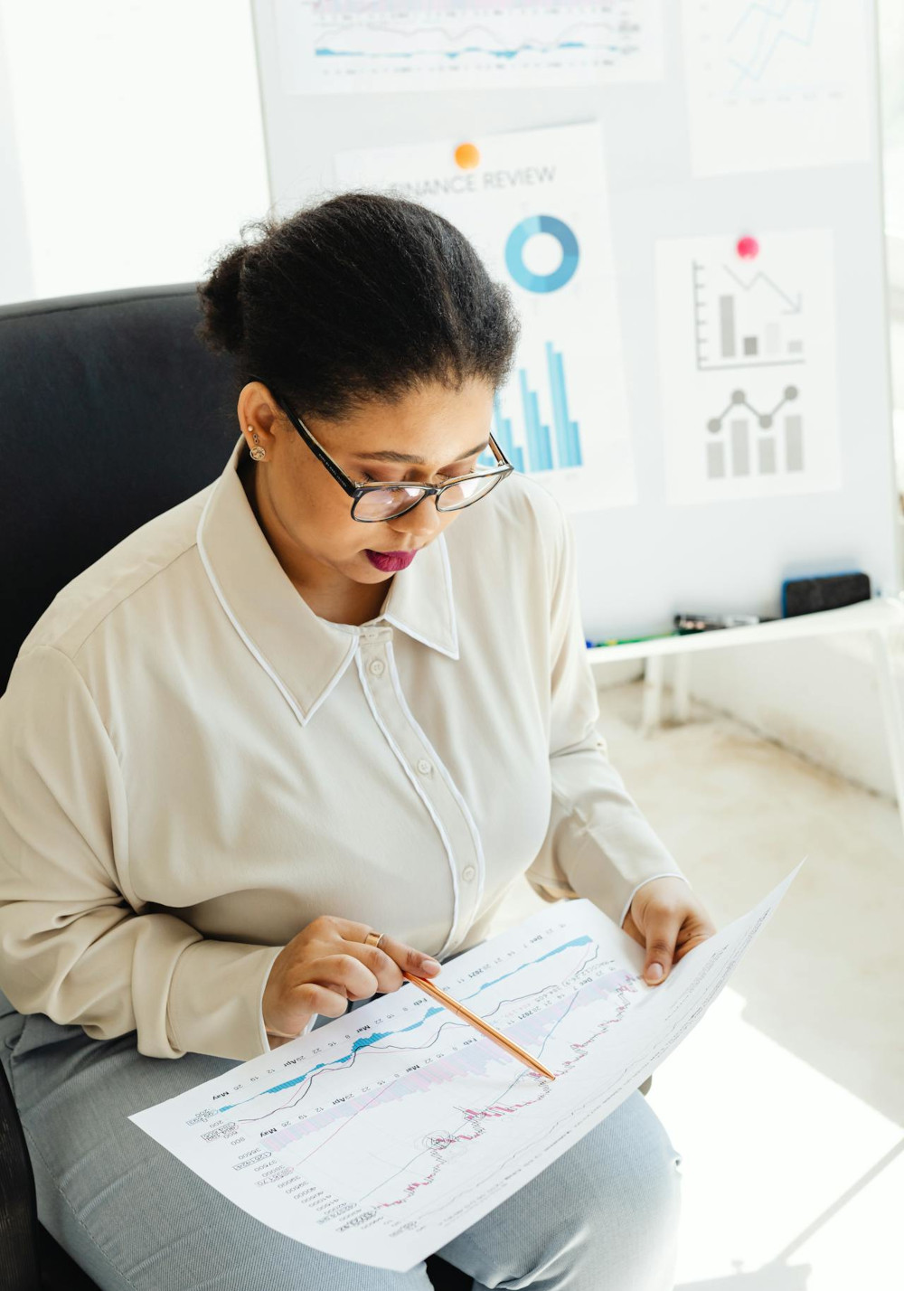 Woman analyzing a printout of performance metrics