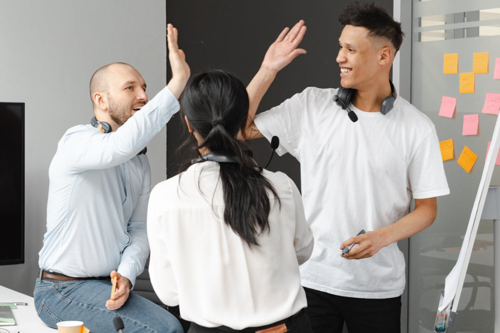 From work abstraction to accountability Colleagues high-fiving their shared success