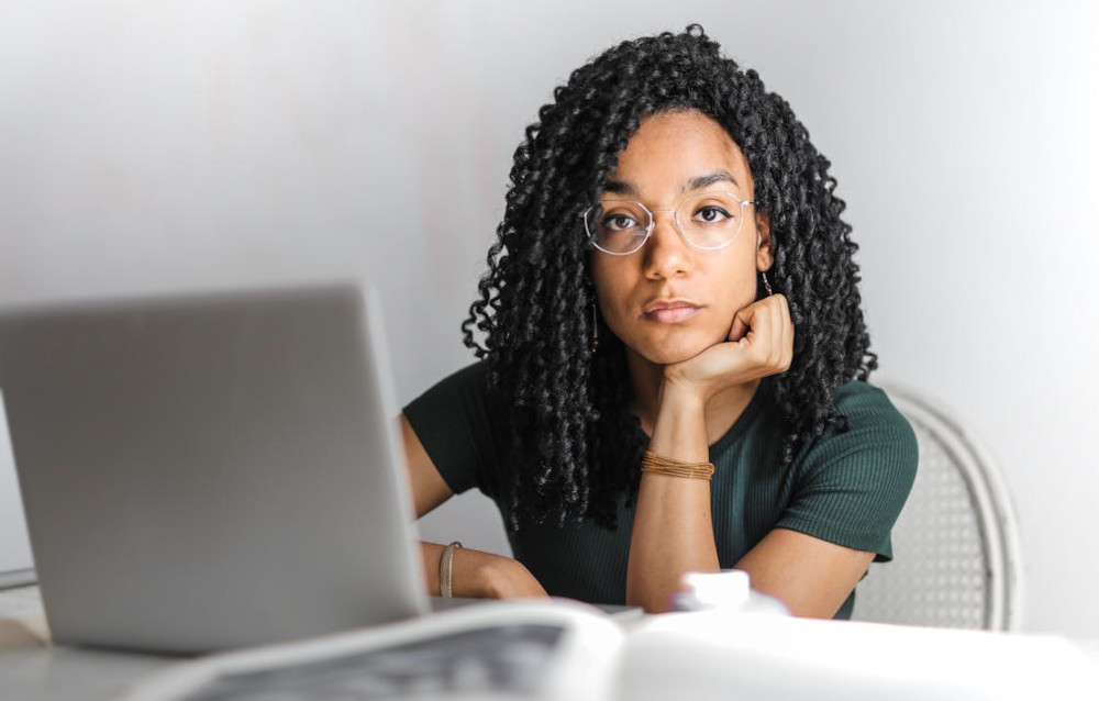 How are boards capable of lying A woman appears confused and unsure while looking at her laptop screen
