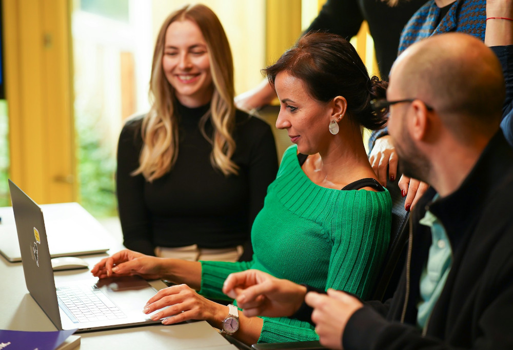 Colleagues working together in front of a laptop