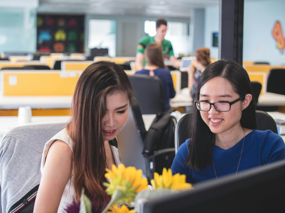 Colleagues working calmly at a shared office desk