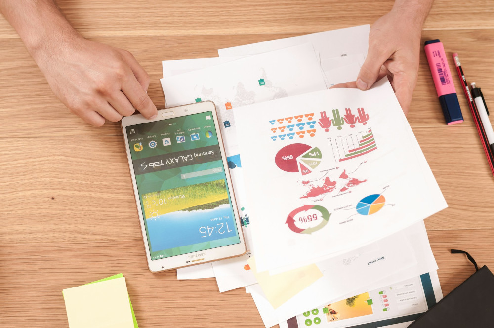 Process charts and metrics printouts sitting on a conference table