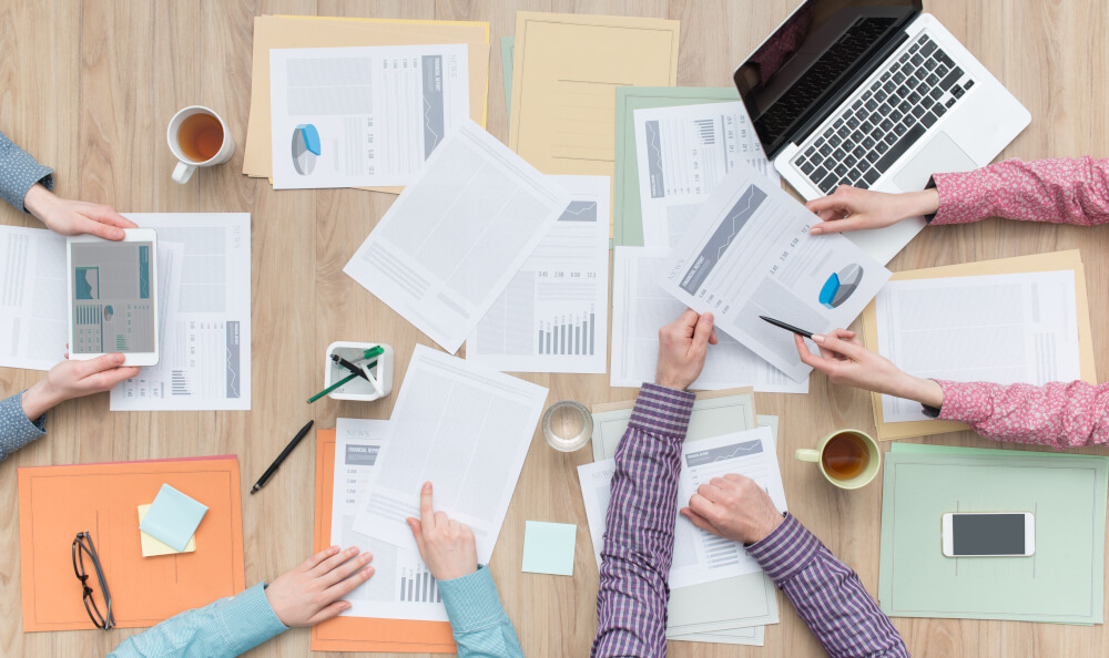 Performance charts spread across a table in an office