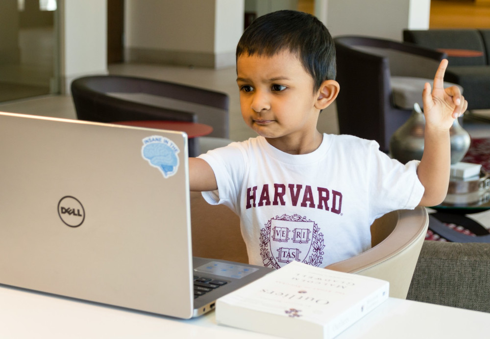 A boy with a laptop is asking a question