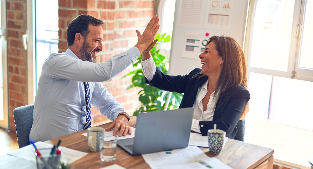 Colleagues working together at an office desk