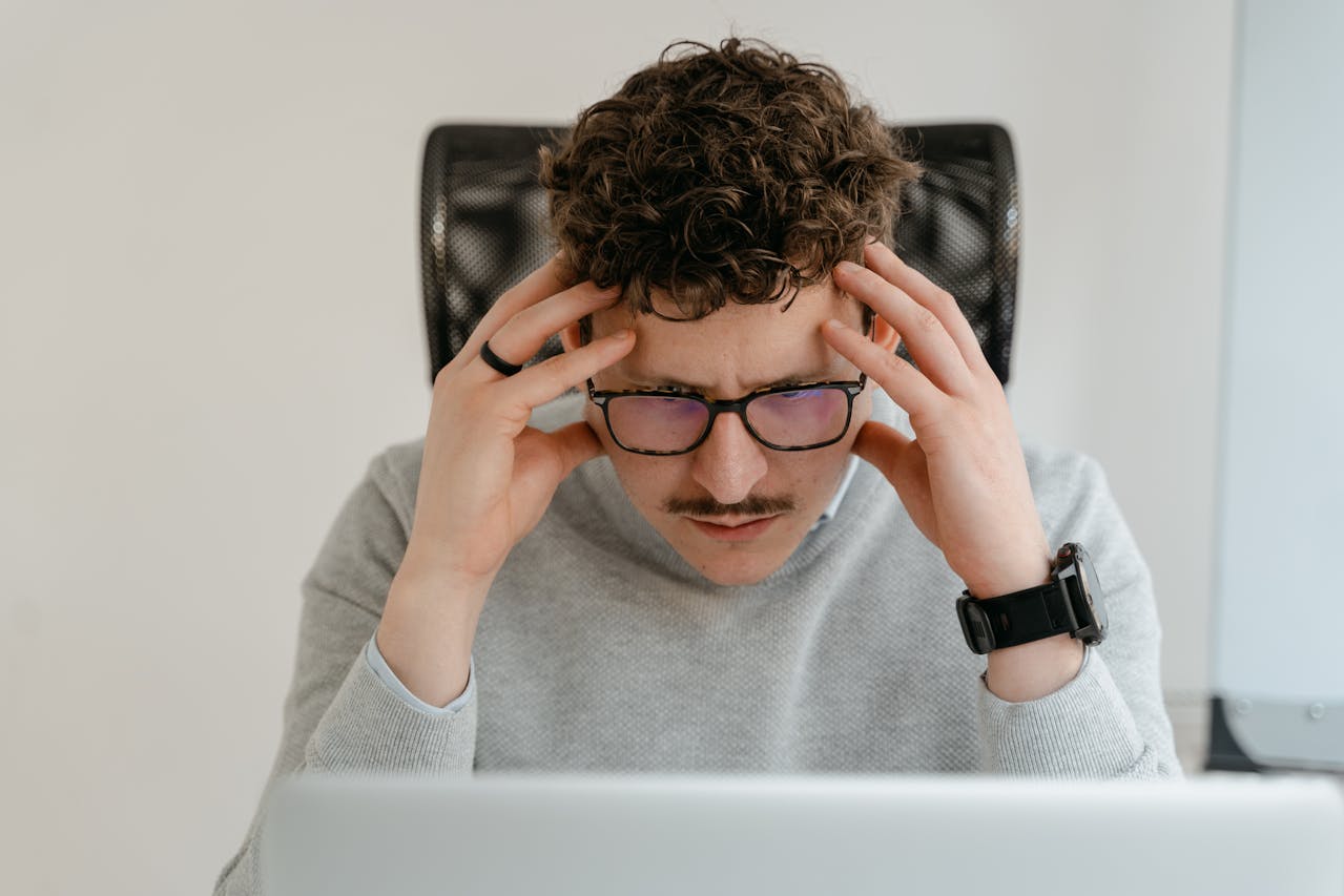 A man appears puzzled looking at his pc screen