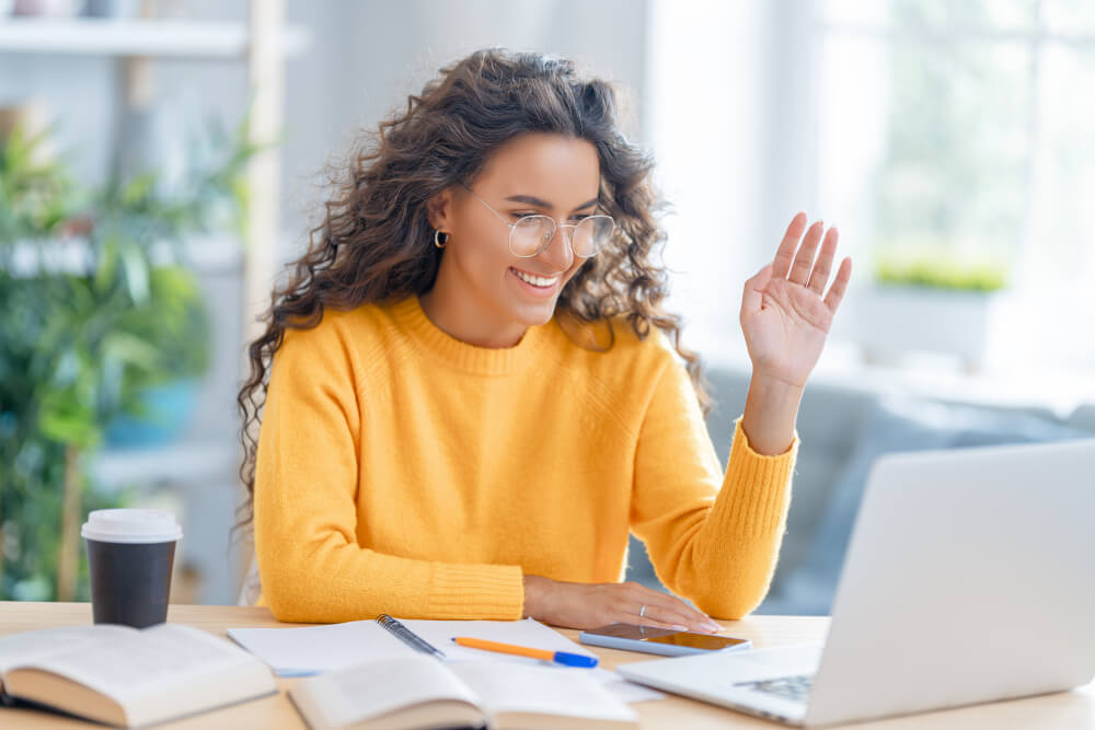 Woman at her home office is using video conferencing tools