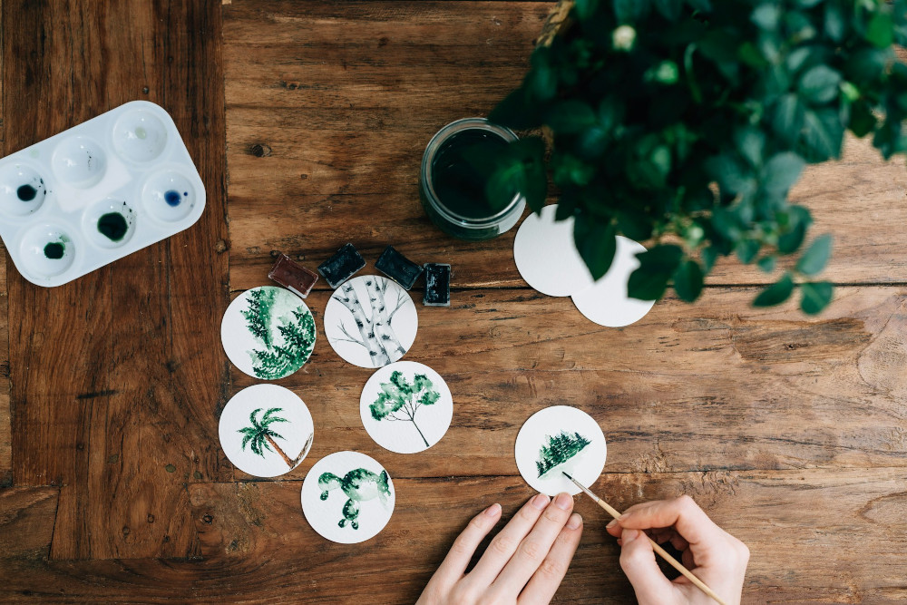 Preparing botanical-themed designs at a desk