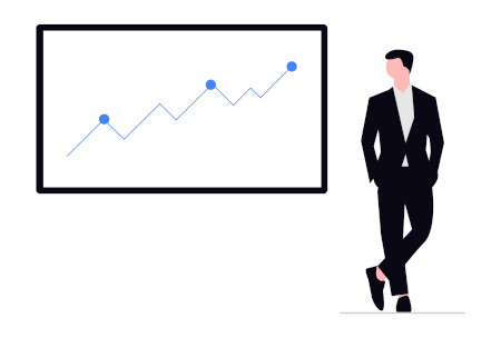 Businessman stands in front of a statistic chart