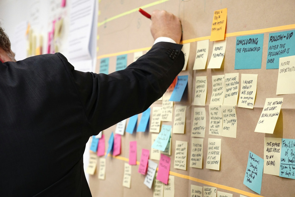 Man working with a physical scrum board